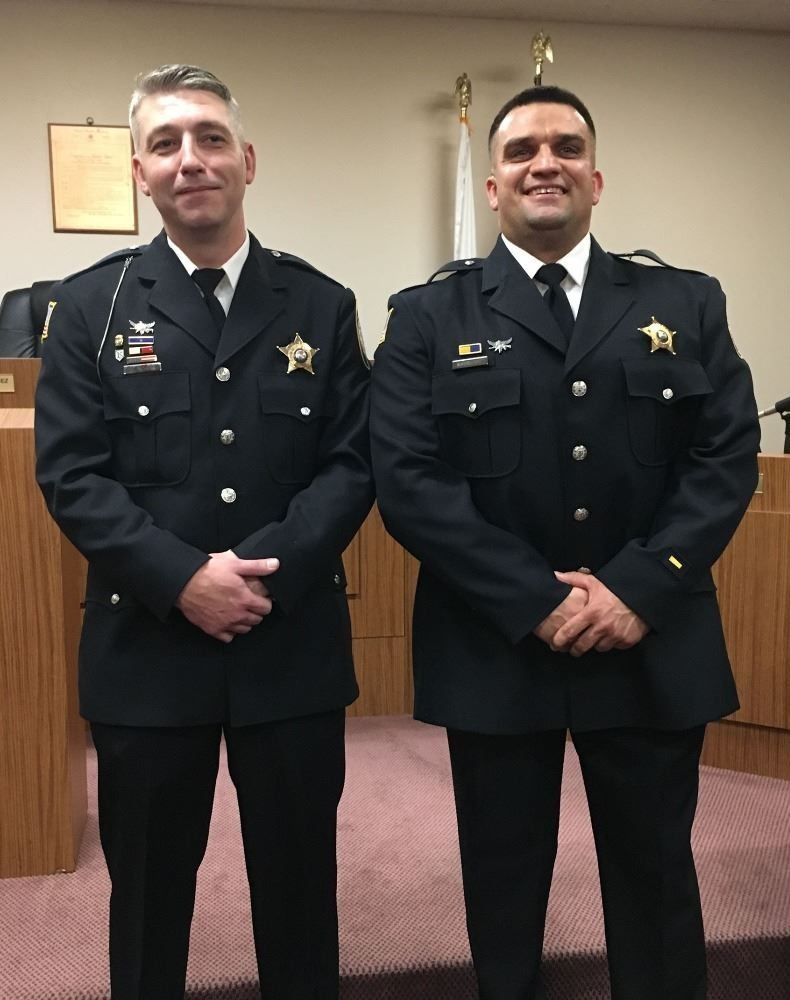 Sergeant Flinchum and Sergeant Makowski standing for photos at the Village board meeting on December